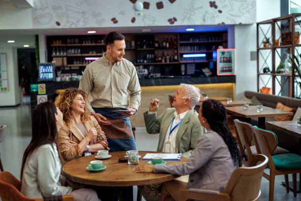 istock Waiter taking orders from group of business people at office cafeteria 2097190377