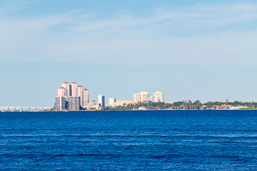 View over the Caloosahatchee River to the Fort Myers skyline and two  motorboats. The Caloosahatchee River between Cape Coral and Fort Myers, Florida, USA.