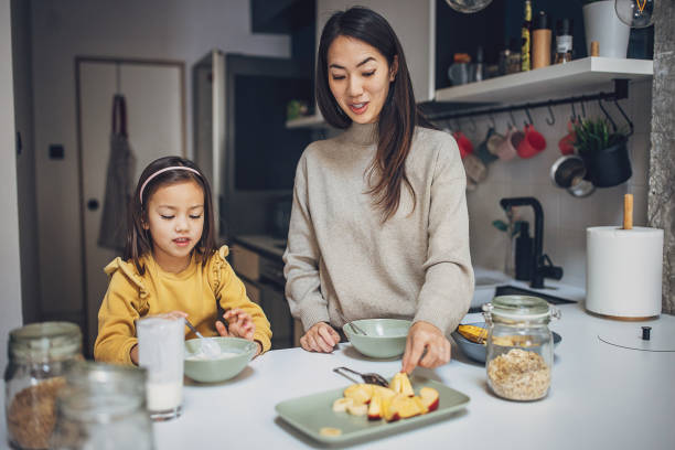 istock Woman and daughter having breakfast 2097245539