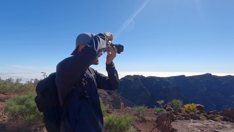 Photographer capturing the beauty of the nature in a mountain