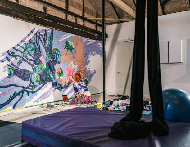 istock Young Caucasian woman creating indoor mural at the gym 2097276521