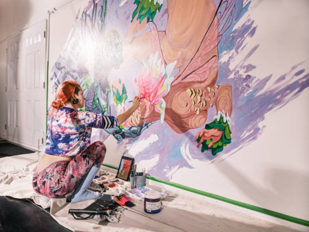 istock Young Caucasian woman creating indoor mural at the gym 2097276530