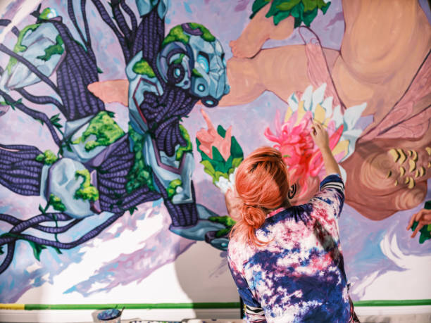 istock Young Caucasian woman creating indoor mural at the gym 2097276531