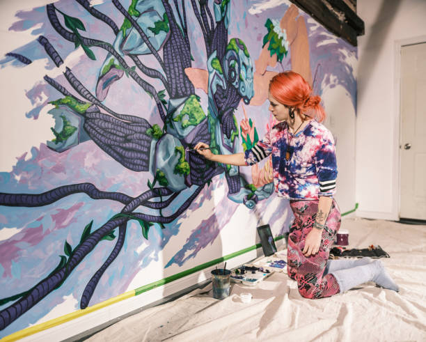 istock Young Caucasian woman creating indoor mural at the gym 2097277042