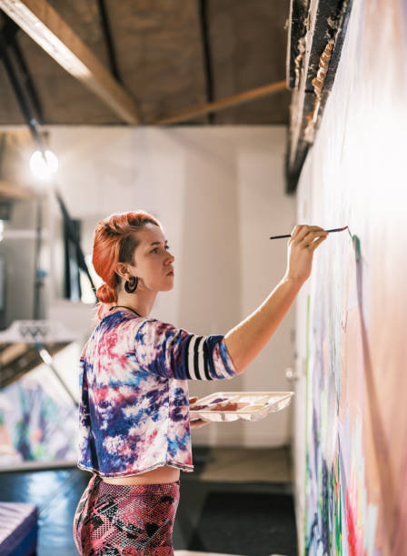 istock Young Caucasian woman creating indoor mural at the gym 2097279640