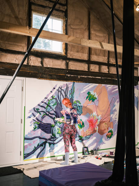 istock Young Caucasian woman creating indoor mural at the gym 2097279645