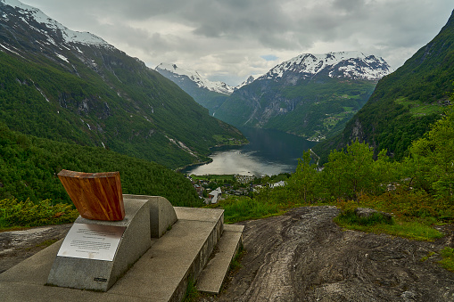Beautiful Geiranger Fjord is a well known and popular travel destination for cruise ships and offers spectacular views to the norwegian landscape with deep gorges and snow covered mountain ranges.