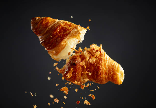 istock Croissant in air on a black background. 2097293554