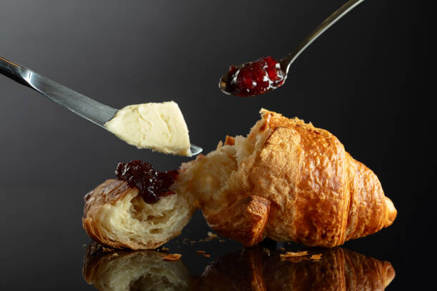 istock Fresh baked croissant with butter and raspberry jam. 2097293676