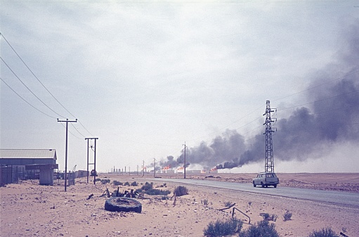 Mauritania (Morocco?), Western Sahara, 1976. Country road in Western Sahara, in the background an oil production facility.