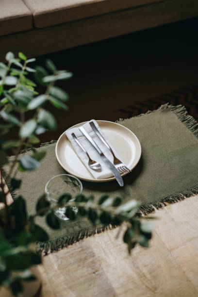 Cutlery on a textured green napkin, elegant table setting detail