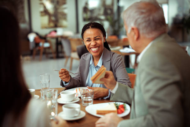 Group of well dressed colleagues having lunch together at the restaurant