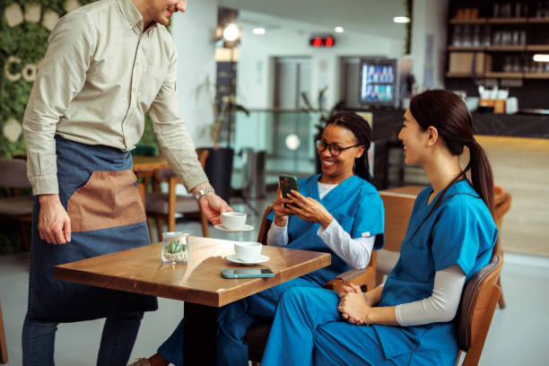 istock Medical workers getting their coffee served by waiter at cafe 2097327729