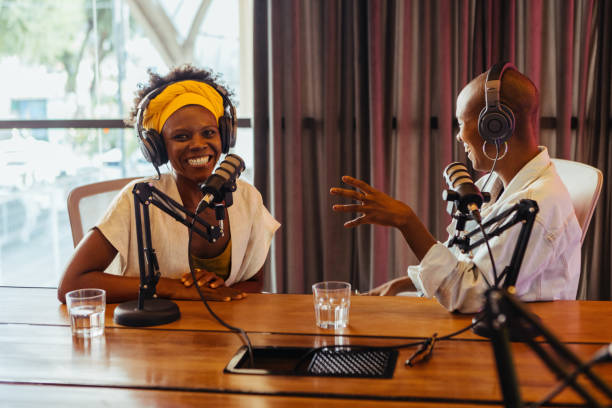 istock Two happy podcast hosts engaged in a lively conversation in a studio setting 2097328760
