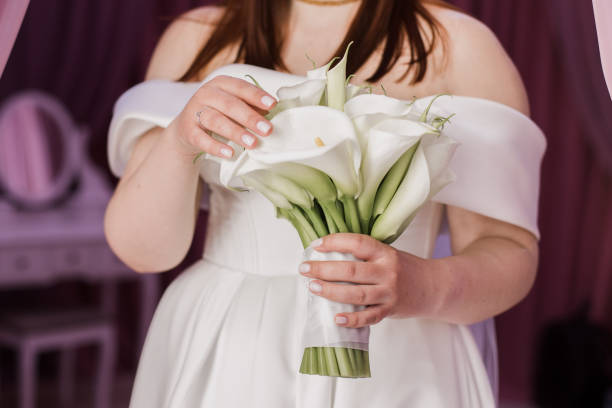 istock the bride holds a wedding bouquet in her hands with a groom 2097335580