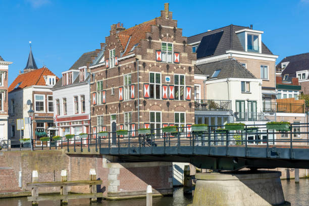 Gorinchem, the Netherlands. 27 February 2024. Typical houses with red and white shutters on the window in the fortified city Gorinchem along the bridge and canal Linge.