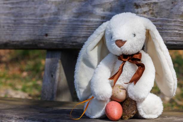 istock Spring's Gentle Embrace: Easter Bunny with Pastel Eggs 2097423576