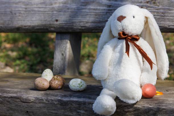 istock Spring's Gentle Embrace: Easter Bunny with Pastel Eggs 2097423581