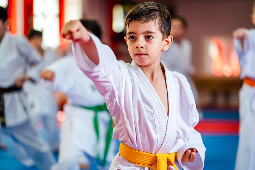 karate training of a little boy in a kimono, yellow belt