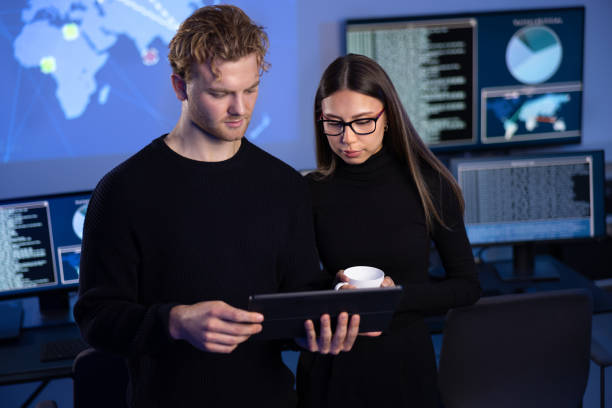istock Two professionals in cyber security team working to prevent security threats, find vulnerability and solve incidents 2097434825