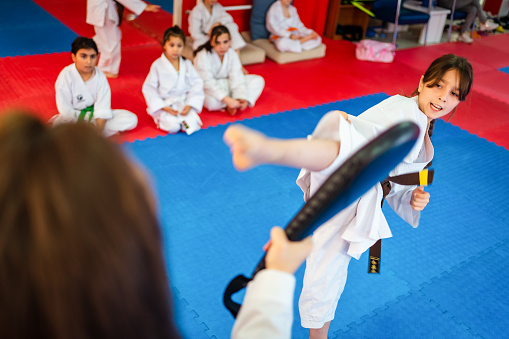 karate training of a little girl in a kimono