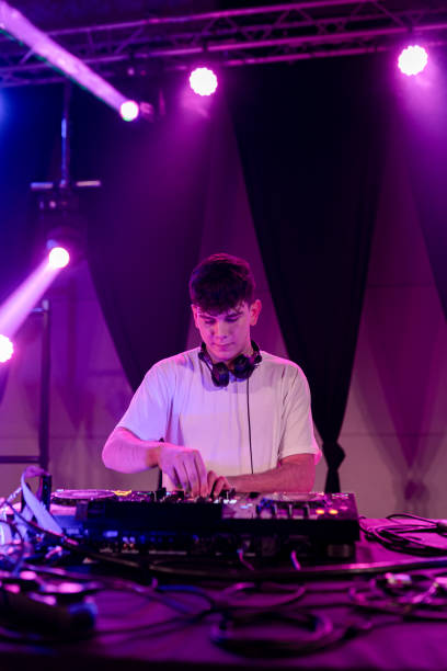 istock DJ working on stage electronic music in a club 2097451064