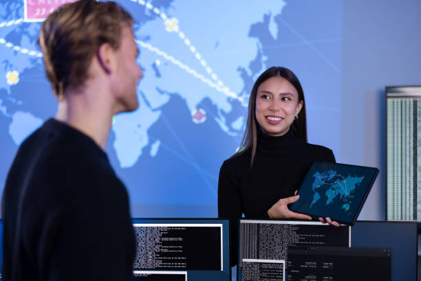 istock Smiling cyber security team working in a Cyber Security Operations Center SOC to protect systems and technologies 2097460597