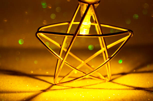 Gold star against shiny sparks background Golden glitter texture Colorfull Blurred abstract background for birthday wedding new year eve or Christmas Bokeh effect New year Birthday template
