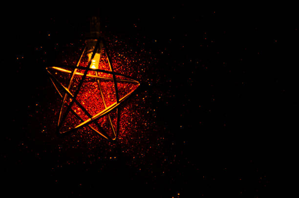 Gold star against shiny sparks dark background Golden glitter texture Colorful Blurred greeting template birthday wedding new year eve Christmas Bokeh effect New year Birthday template Copy space