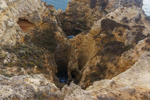 Rock formation of cliff at the atlantic coast line near Ponta da Piedade, Lagos, Algarve, Portugal.