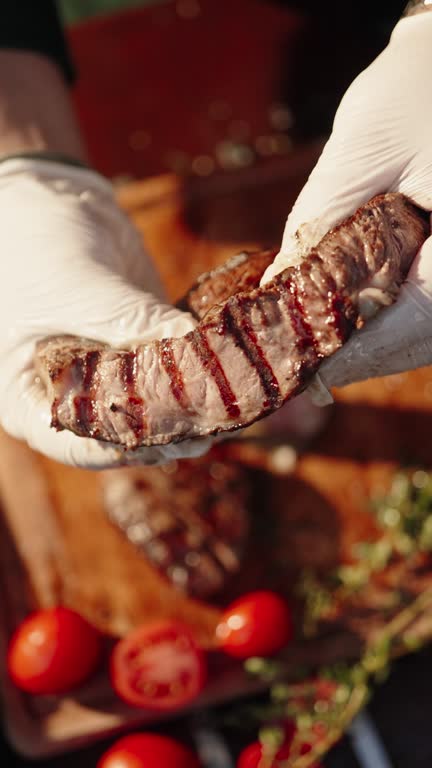 Chef holds up the best part of a juicy fresh piece of freshly cooked, ready to eat t-bone steak