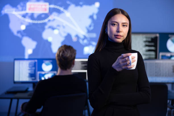 istock Professional Female IT Consultant holding coffee cup in large Cyber Security Operations Center SOC handling Threats 2097526113