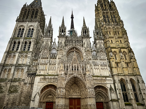 Rouen, France - 19.02.2024. Rouen Cathedral (Cathedrale de Notre-Dame) in Rouen, capital of Haute-Normandie, France. The facade of the Gothic church building, it is famous for its three towers, each in a different style.