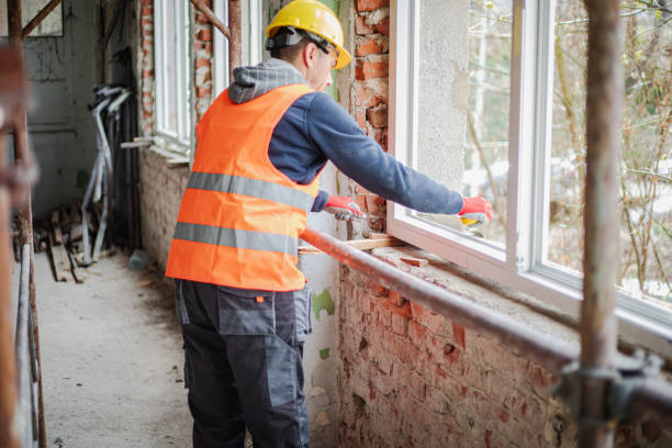 istock Construction worker installs new windows on residential building, renovation 2097560764