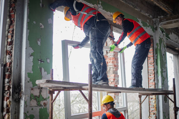 istock Construction workers are installing new windows on a residential building, renovating the building 2097560775