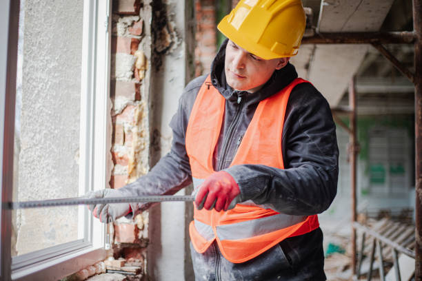 istock Construction worker installs new windows on residential building, renovation 2097563397