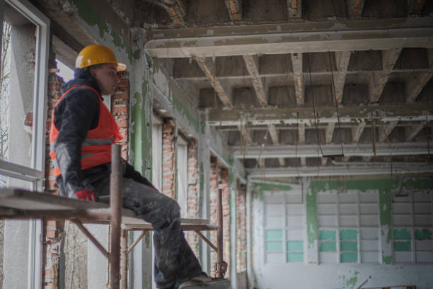 istock Construction worker installs new windows on residential building, renovation 2097564218
