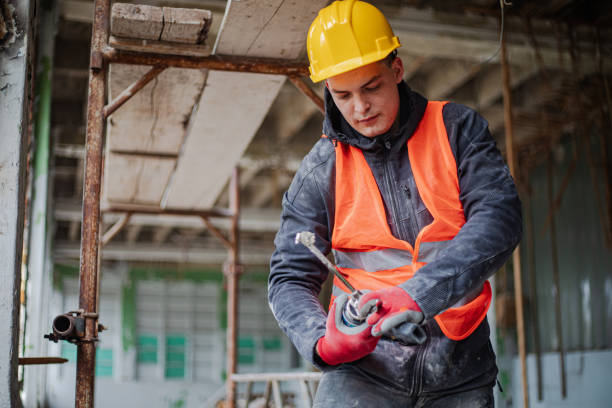 istock Construction worker installs new windows on residential building, renovation 2097564439