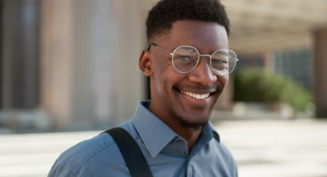 Happy, city and face of business black man for travel, morning commute and journey to building. Professional, African and portrait of worker in glasses for career, job and work opportunity in town