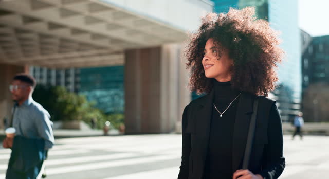 Business, black woman and walking by city building with thinking and smile for morning travel or journey outdoor. Happiness, person with afro and corporate worker moving to work in urban town