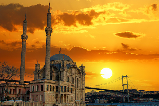 Ortaköy mosque in istanbul with a bridge in the background. Amazing sunset.