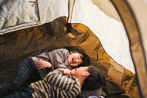 Asian brother and sister enjoy camping.