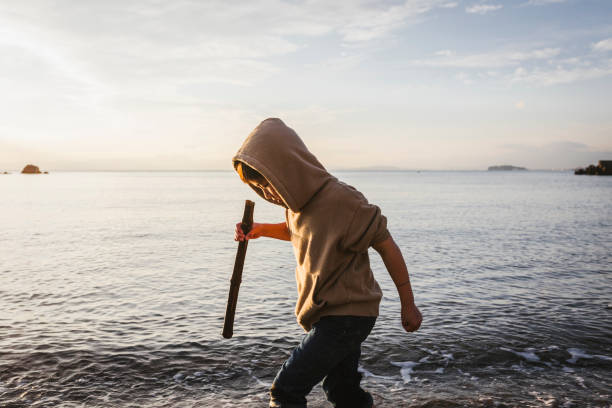 Asian boy exploring at seaside.