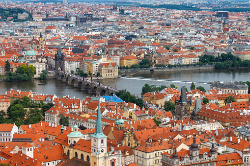 The Charles Bridge (Karluv most), the water clock tower, the old town bridge tower over Vitava river, the Lesser town bridge tower and the large dome of St francis of assisi church in Prague, Czech Republic.