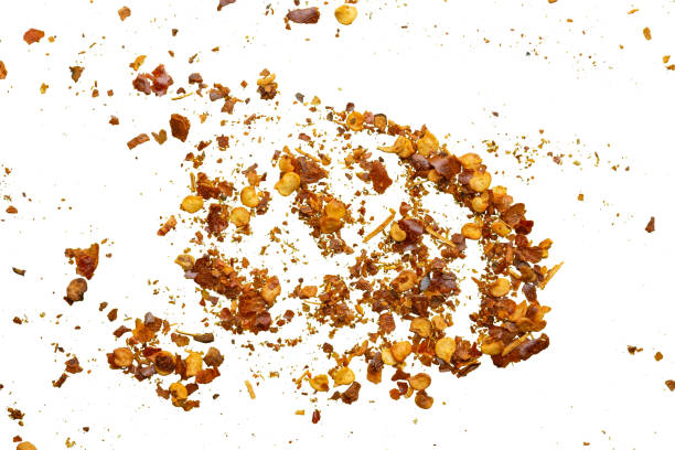 istock dried red chili pepper flakes and seeds isolated on white background 2097744667