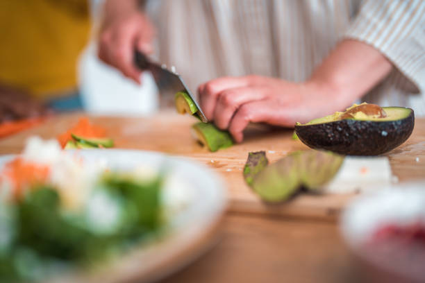 istock Woman Professionally Dicing Ingredients for Healthy Veggie Dish 2097759323