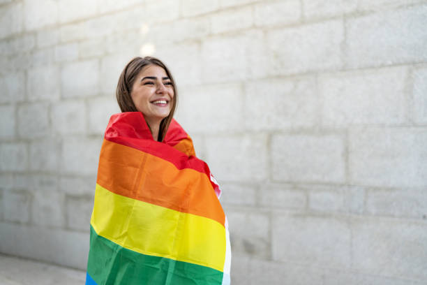 istock Beautiful young woman draped in a rainbow flag 2097767256