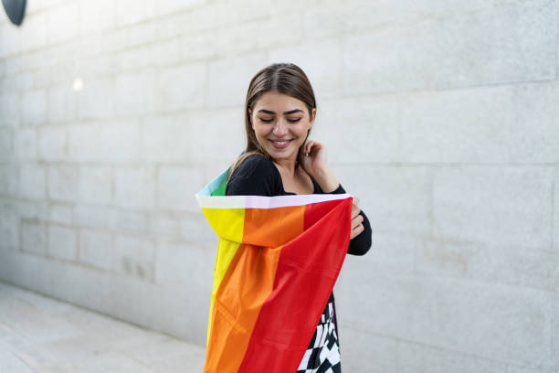 istock Confident beautiful woman holding rainbow flag 2097777086
