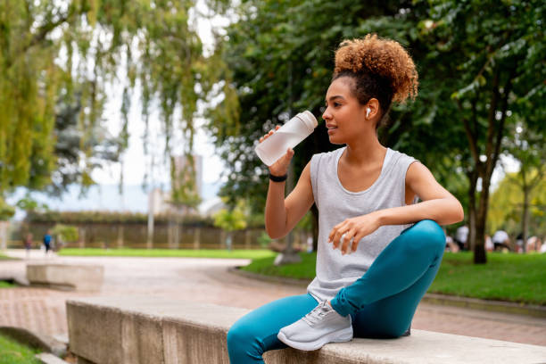 Runner at the park taking a break to drink some water