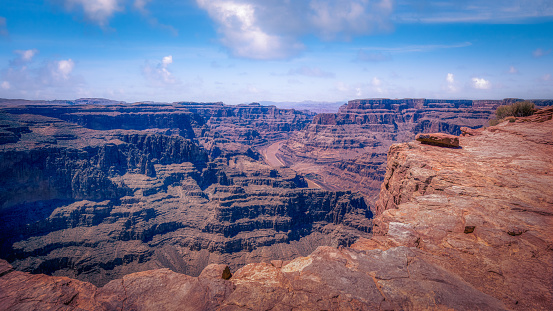 Daytime view of the Grand Canyon from the edge of a cliff.
